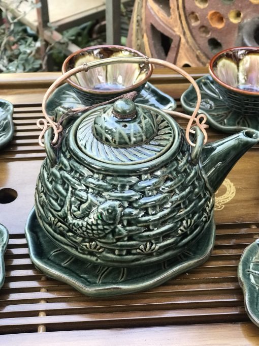 High-end Bat Trang artisan tea set with lotus and fish design.